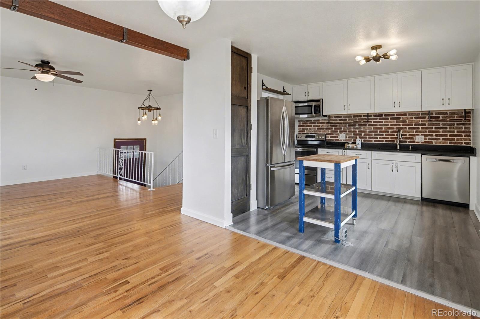 9142 Oberon Road Arvada, CO 80004 - Photo 3 of 35 a kitchen with stainless steel appliances granite countertop a refrigerator and a stove top oven
