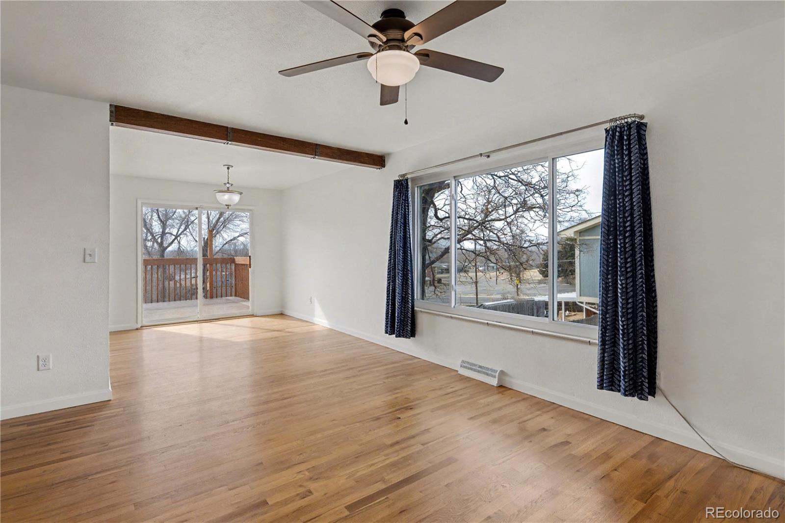 9142 Oberon Road Arvada, CO 80004 - Photo 4 of 35 wooden floor in an empty room with a window