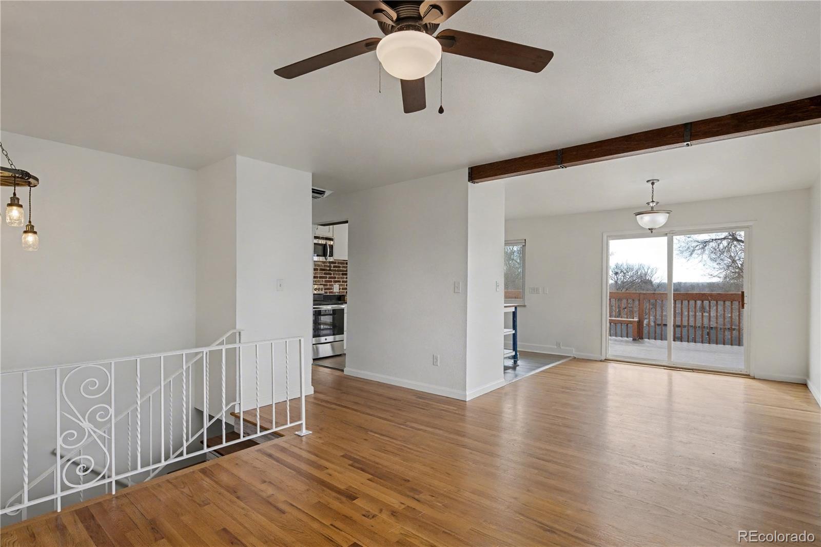 9142 Oberon Road Arvada, CO 80004 - Photo 6 of 35 wooden floor in an empty room with a window