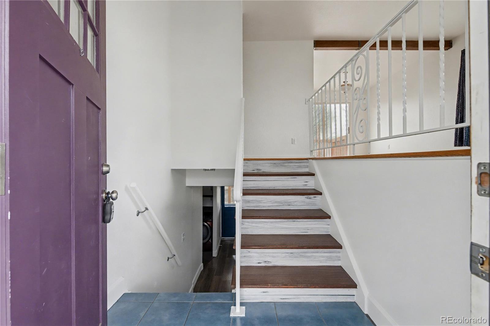 9142 Oberon Road Arvada, CO 80004 - Photo 10 of 35 a view of staircase with white walls and a window