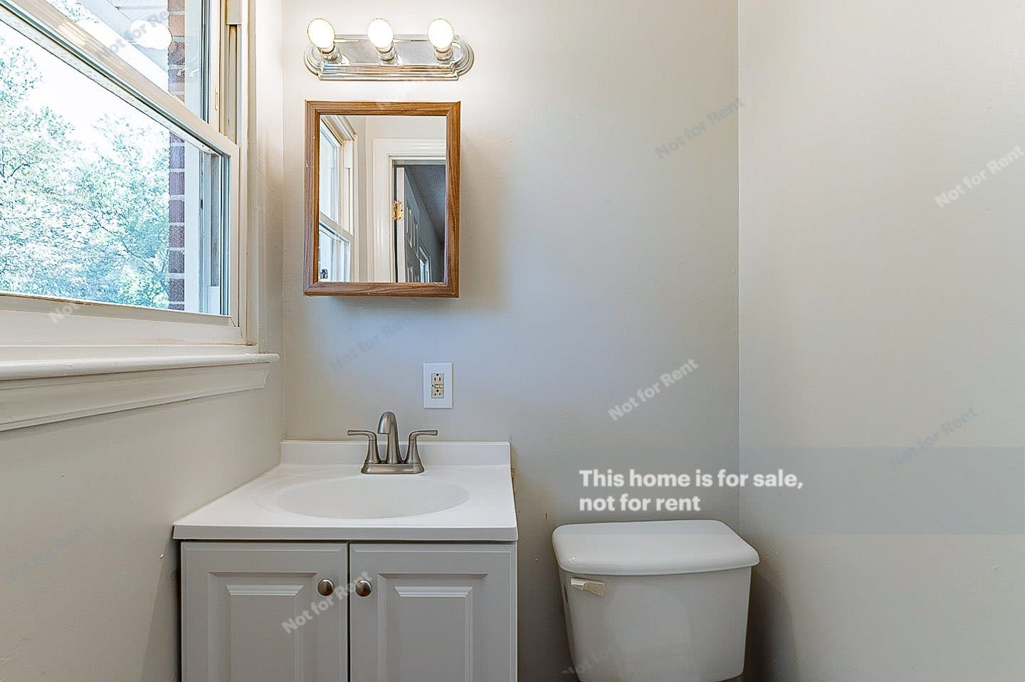 2612 Joyner Road Durham, NC 27704 - Photo 16 of 25 a bathroom with a toilet sink and mirror