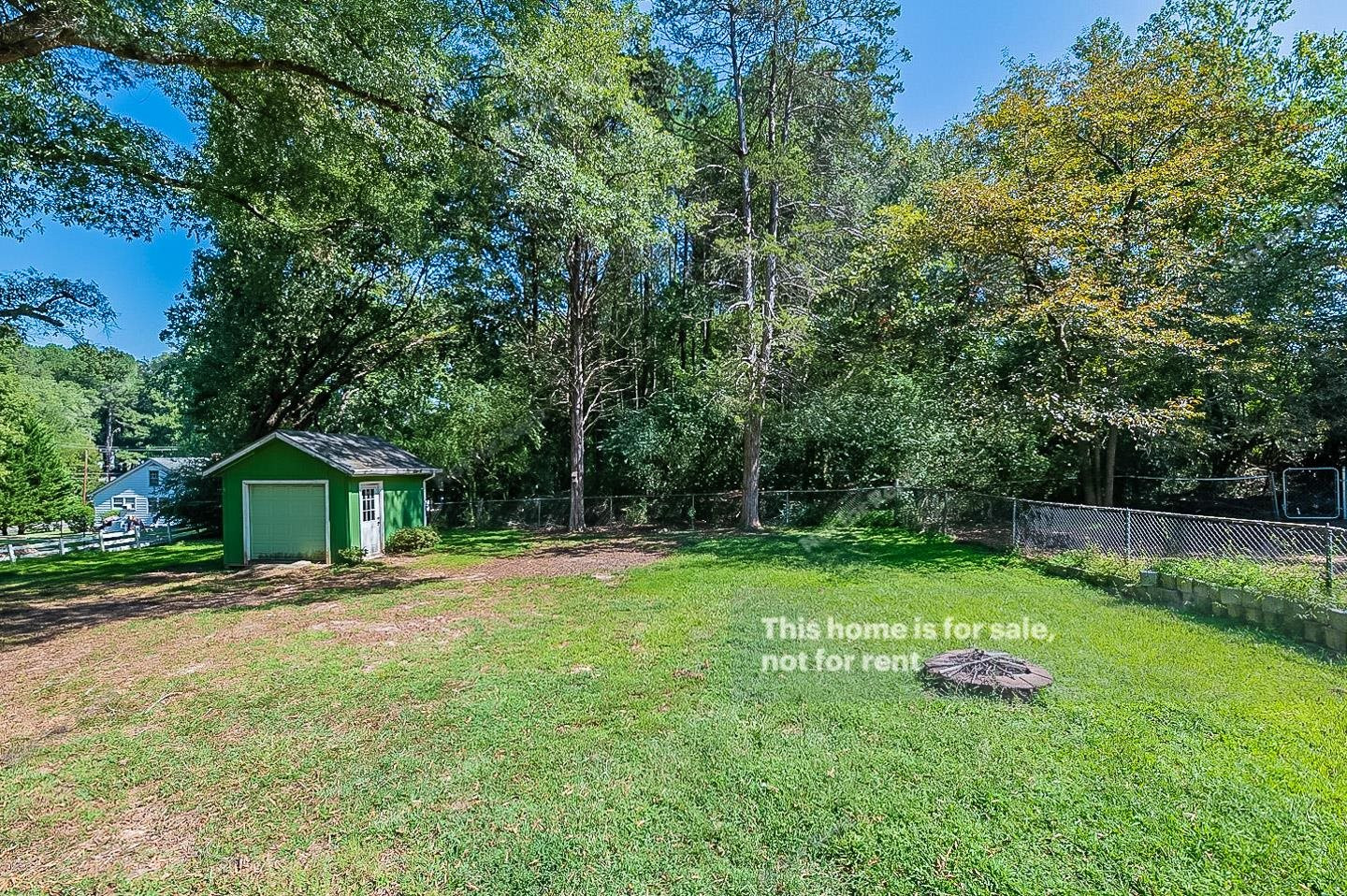 2612 Joyner Road Durham, NC 27704 - Photo 24 of 25 a front view of a house with a yard and trees