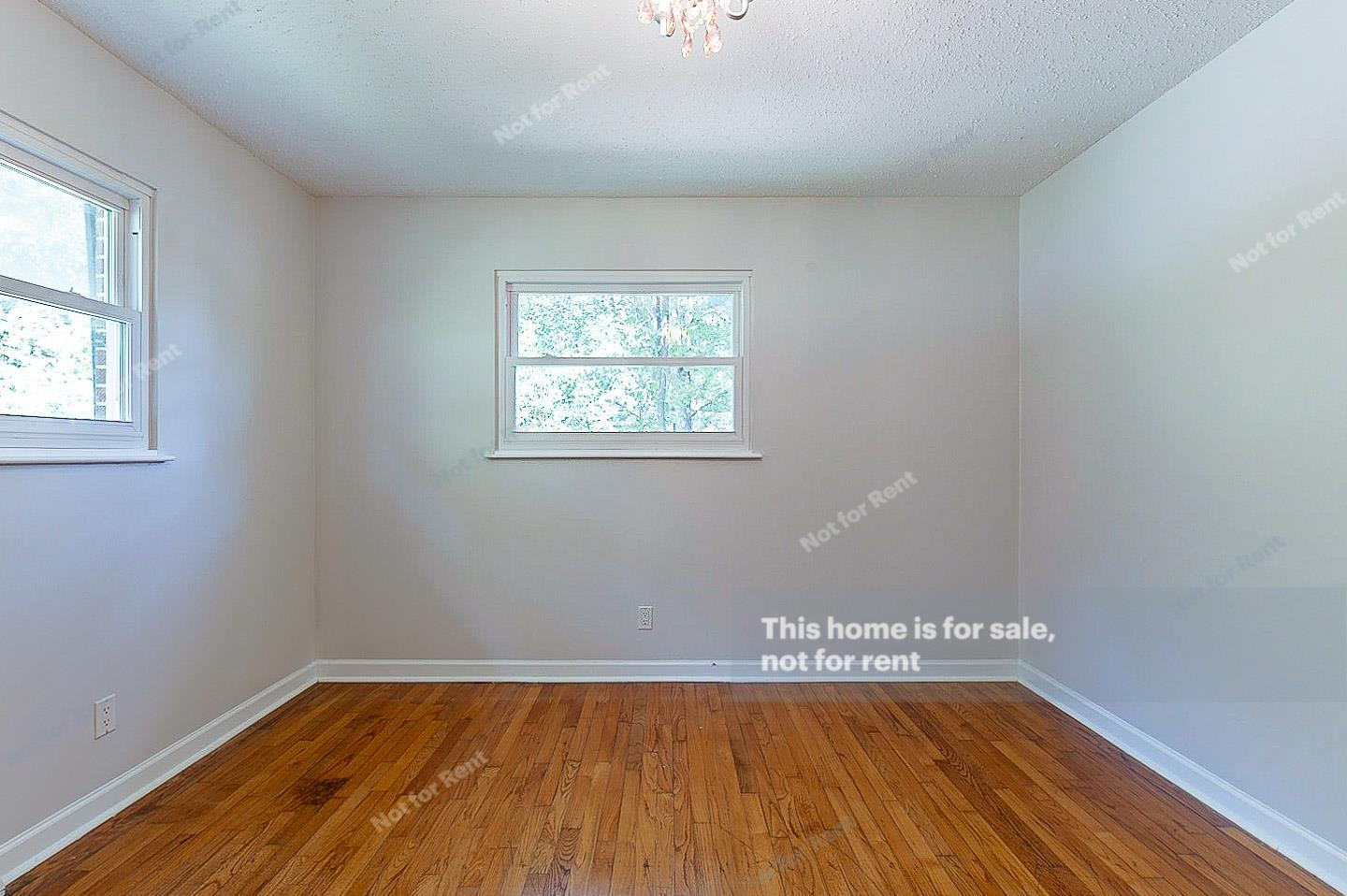 2612 Joyner Road Durham, NC 27704 - Photo 5 of 25 an empty room with wooden floor and windows