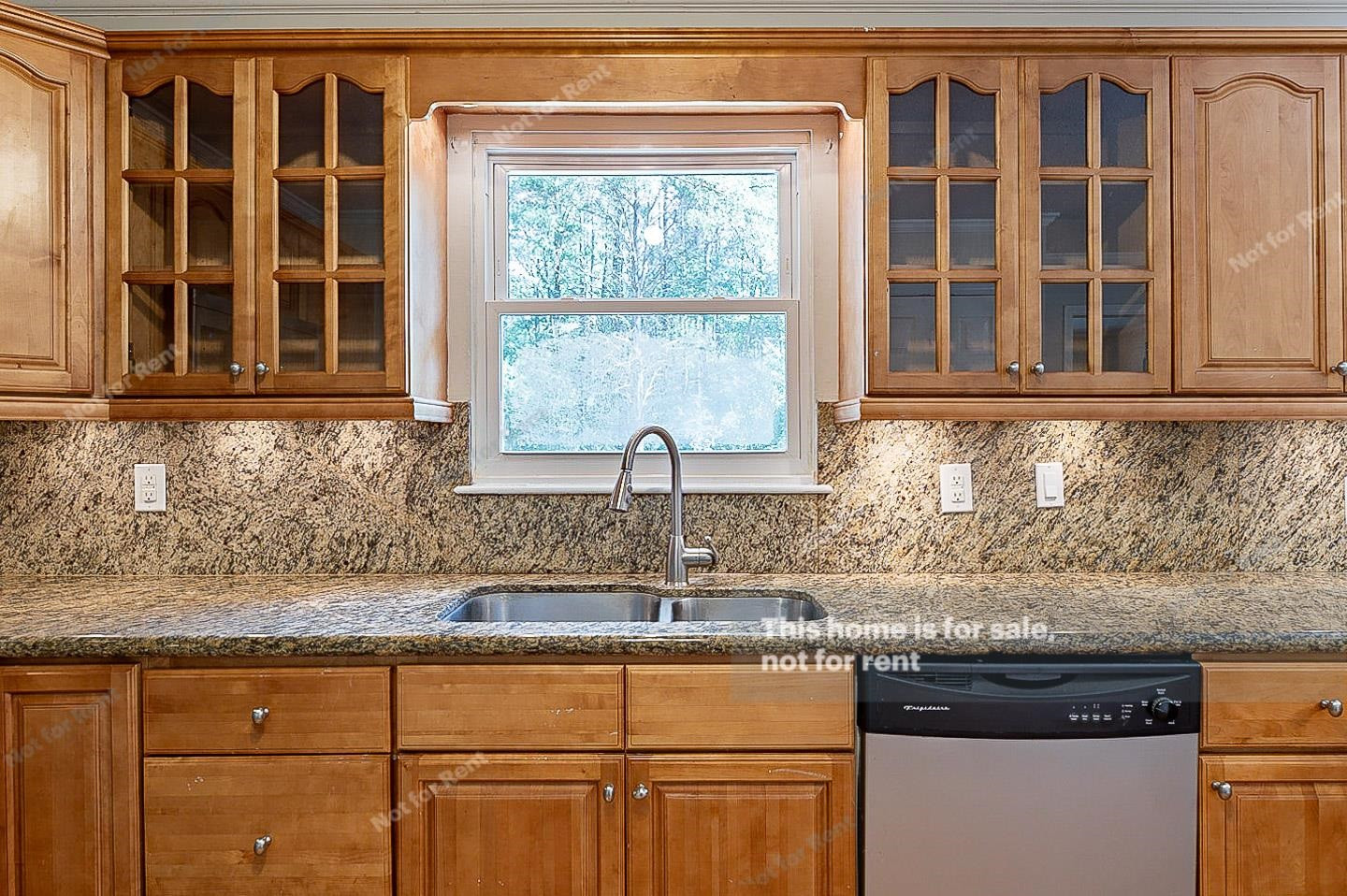 2612 Joyner Road Durham, NC 27704 - Photo 9 of 25 a kitchen with granite countertop a sink window and cabinets