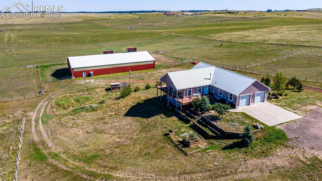 a roof deck with table and chairs and a dining table under an umbrella