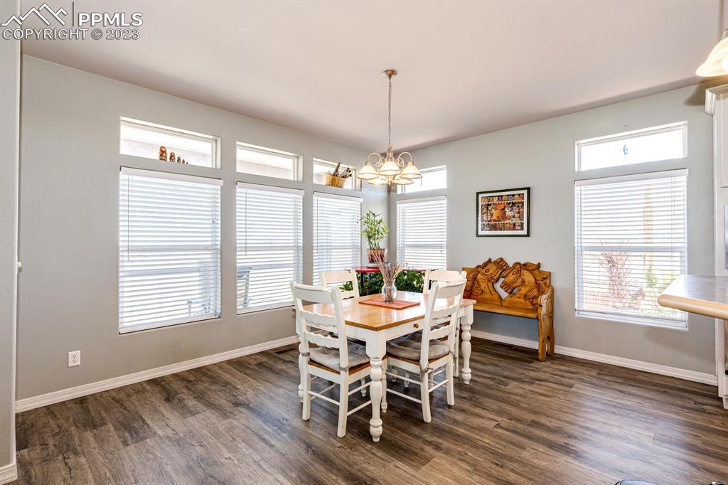 4685 County Road 106 Elbert, CO 80106 - Photo 12 of 43 a dining room with furniture a chandelier and wooden floor