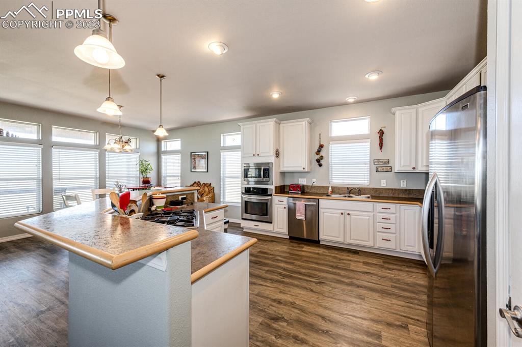 4685 County Road 106 Elbert, CO 80106 - Photo 13 of 43 a kitchen with stainless steel appliances granite countertop a sink refrigerator and cabinets