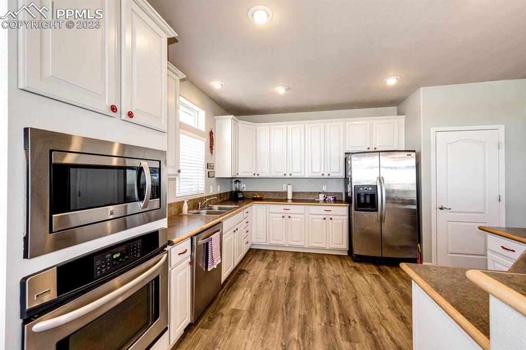 4685 County Road 106 Elbert, CO 80106 - Photo 14 of 43 a kitchen with a sink stainless steel appliances and cabinets