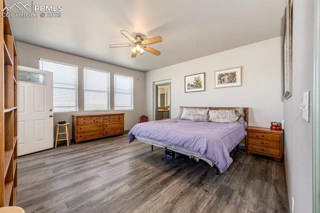 a spacious bedroom with a bed and a chandelier
