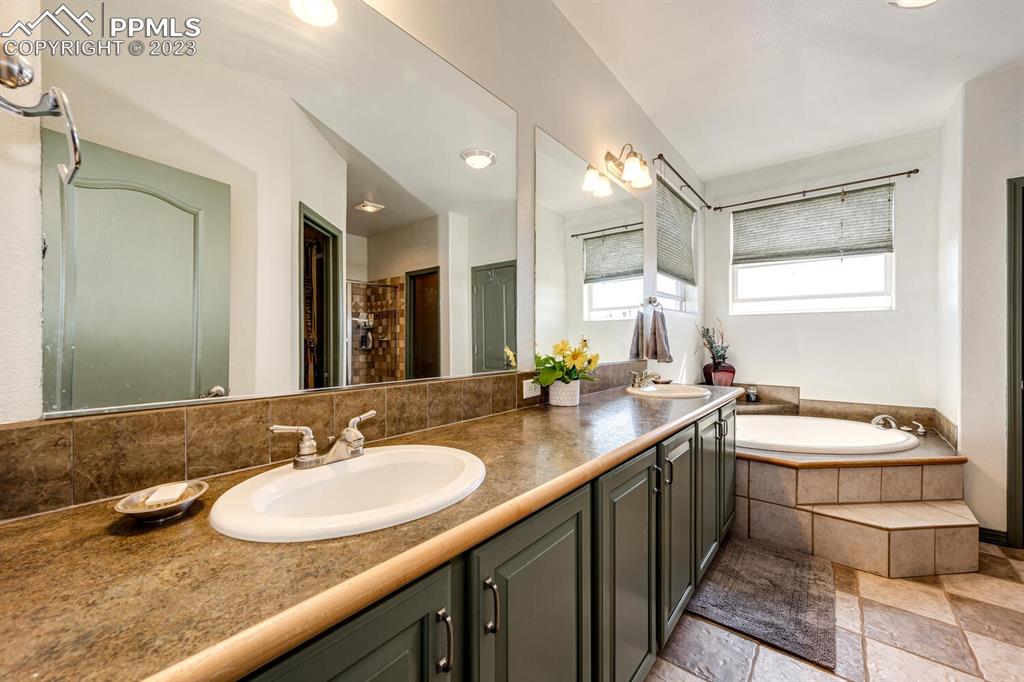 4685 County Road 106 Elbert, CO 80106 - Photo 20 of 43 a bathroom with a sink double vanity and a mirror