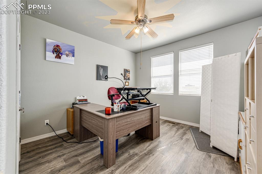 4685 County Road 106 Elbert, CO 80106 - Photo 23 of 43 a bedroom with a bed and a chandelier