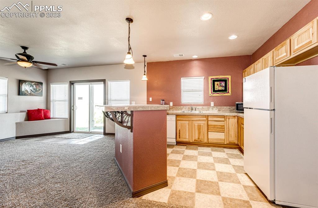 4685 County Road 106 Elbert, CO 80106 - Photo 25 of 43 a kitchen with stainless steel appliances granite countertop a refrigerator sink and white cabinets