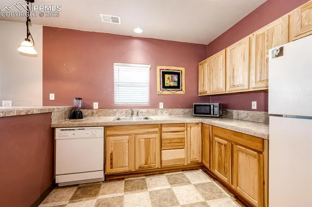 a large kitchen with kitchen island a sink stainless steel appliances and a counter top
