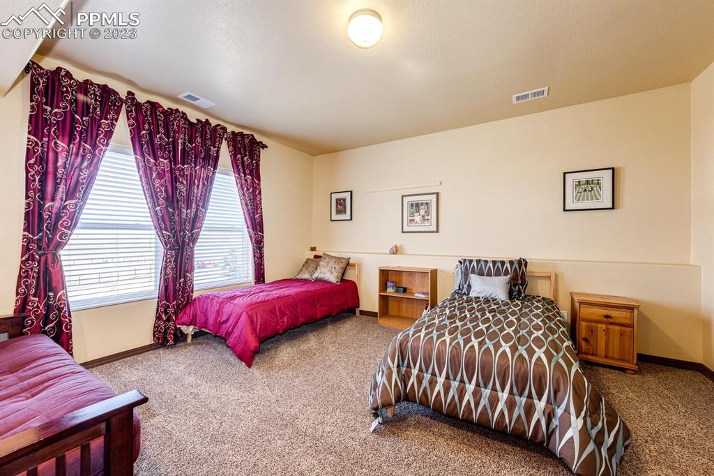 4685 County Road 106 Elbert, CO 80106 - Photo 32 of 43 a bedroom with two beds and a couch
