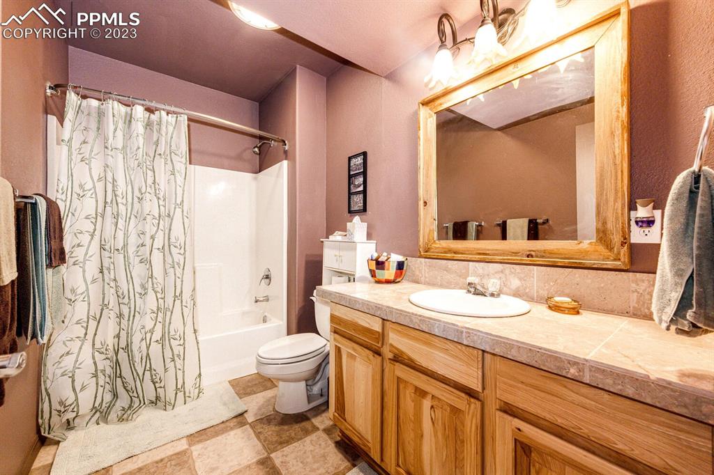 4685 County Road 106 Elbert, CO 80106 - Photo 33 of 43 a bathroom with a double vanity sink toilet mirror and shower