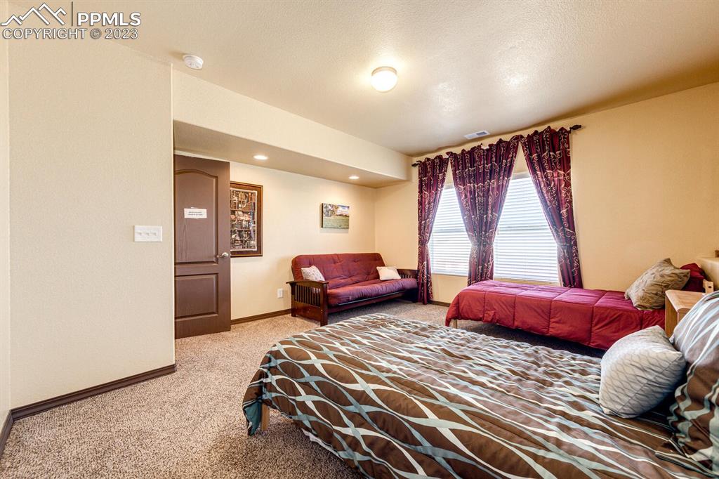 4685 County Road 106 Elbert, CO 80106 - Photo 34 of 43 a bedroom with a bed and glass window