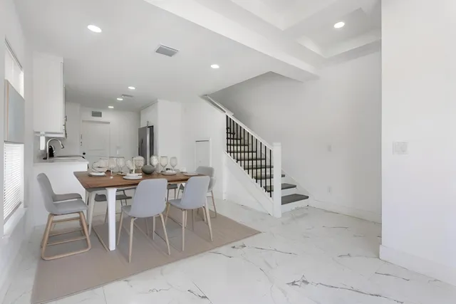 a dining room with furniture and entryway