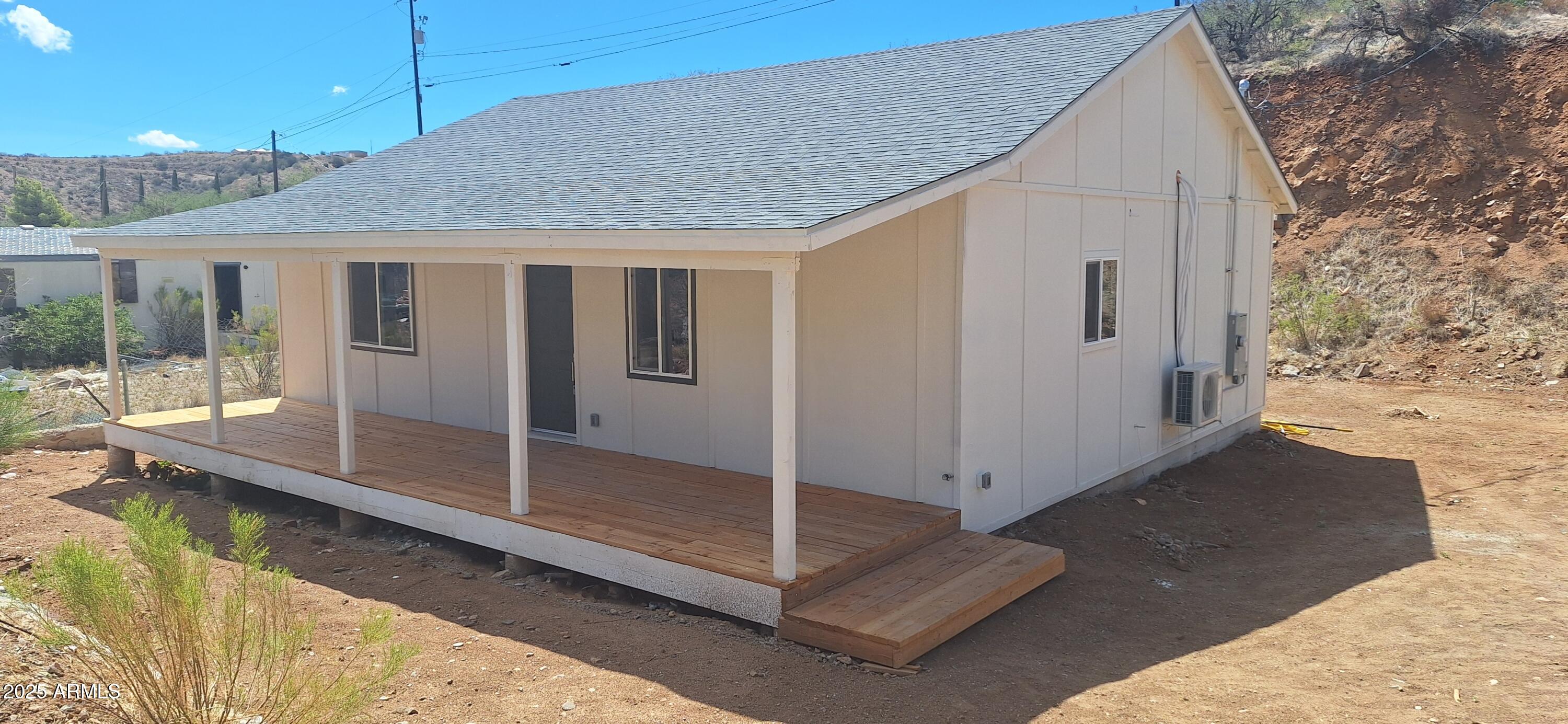 a view of a house with a backyard