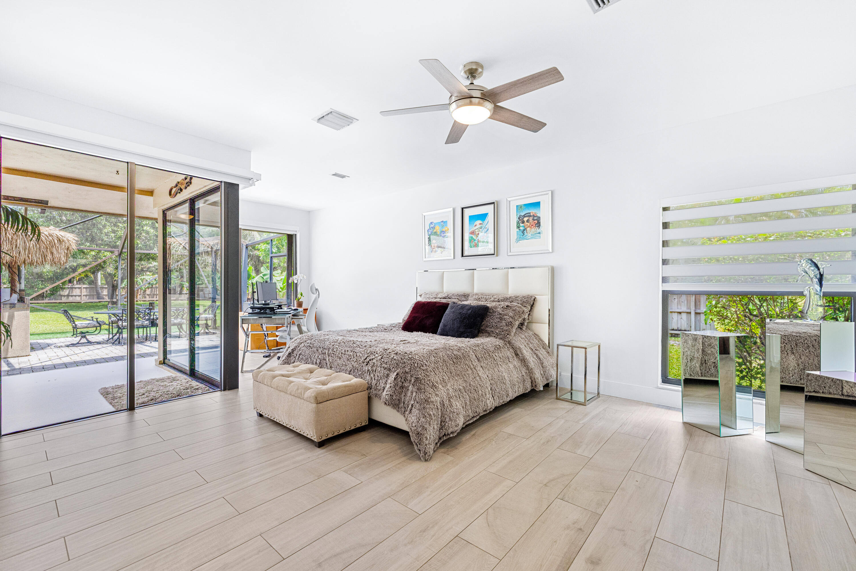 11415 Sundance Lane Boca Raton, FL 33428 - Photo 17 of 65 a spacious bedroom with a large bed and a chandelier