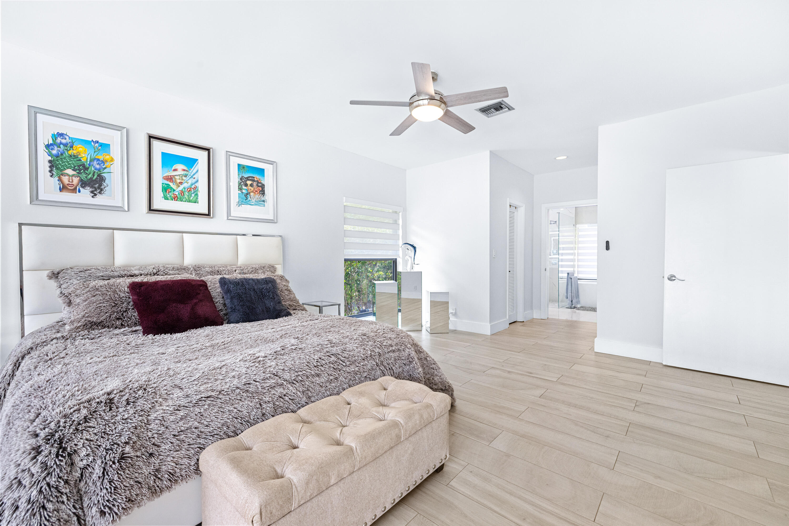 11415 Sundance Lane Boca Raton, FL 33428 - Photo 18 of 65 a bedroom with a large bed and painting on the wall