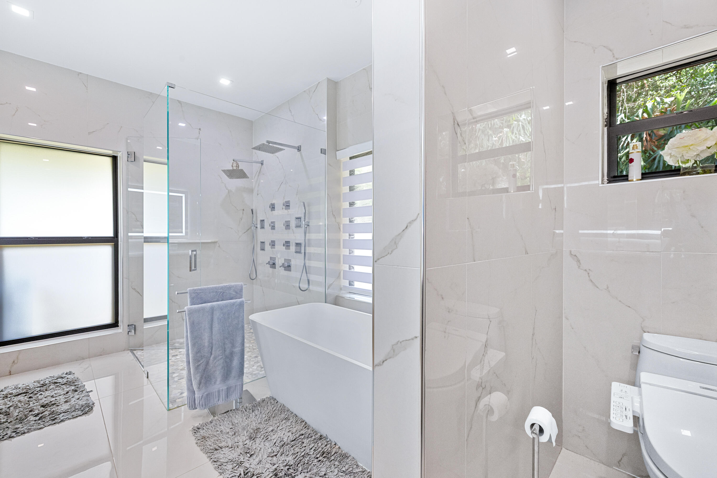 11415 Sundance Lane Boca Raton, FL 33428 - Photo 21 of 65 a bathroom with a bathtub and a shower