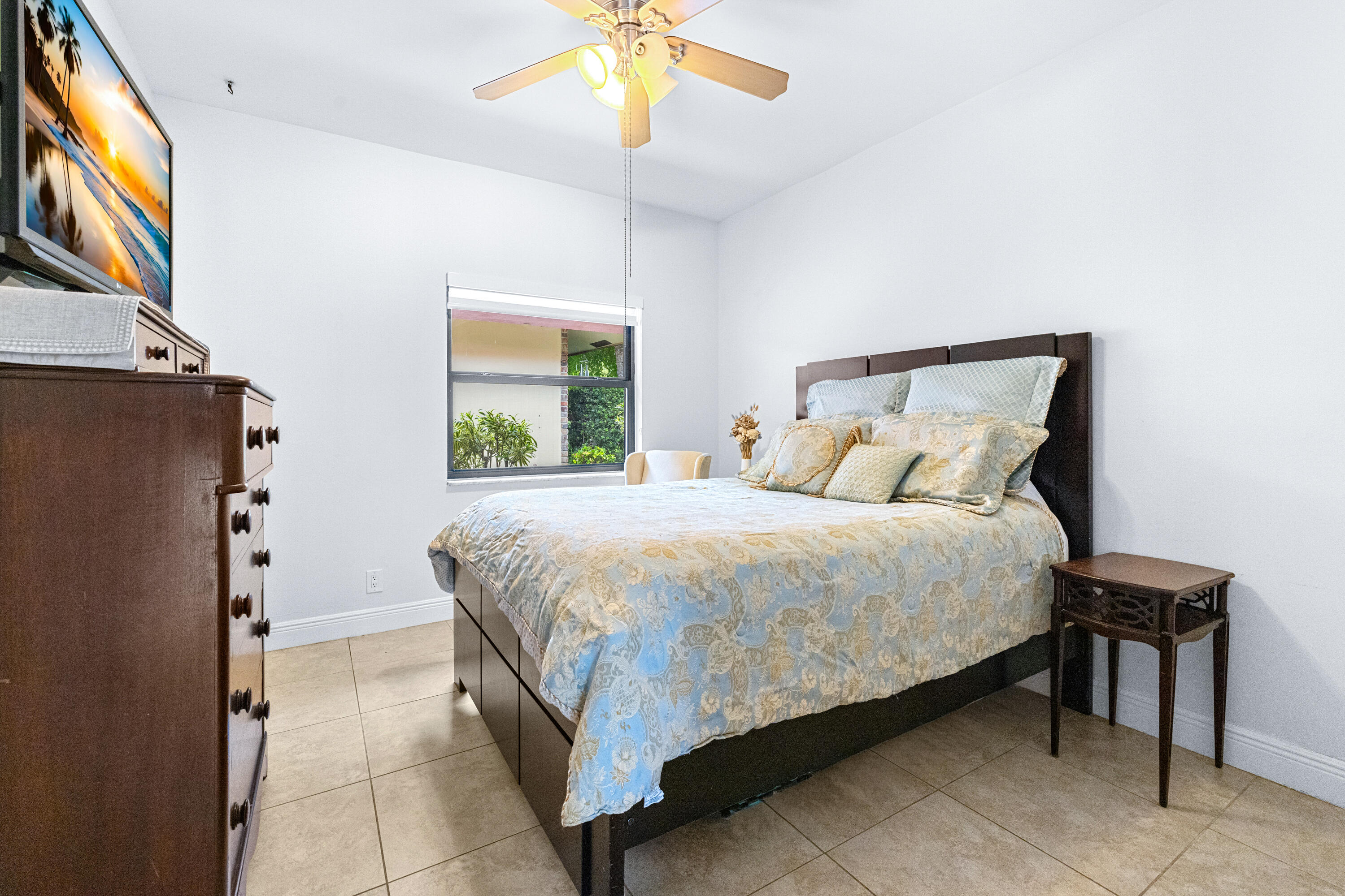 11415 Sundance Lane Boca Raton, FL 33428 - Photo 23 of 65 a bedroom with a bed and a chandelier