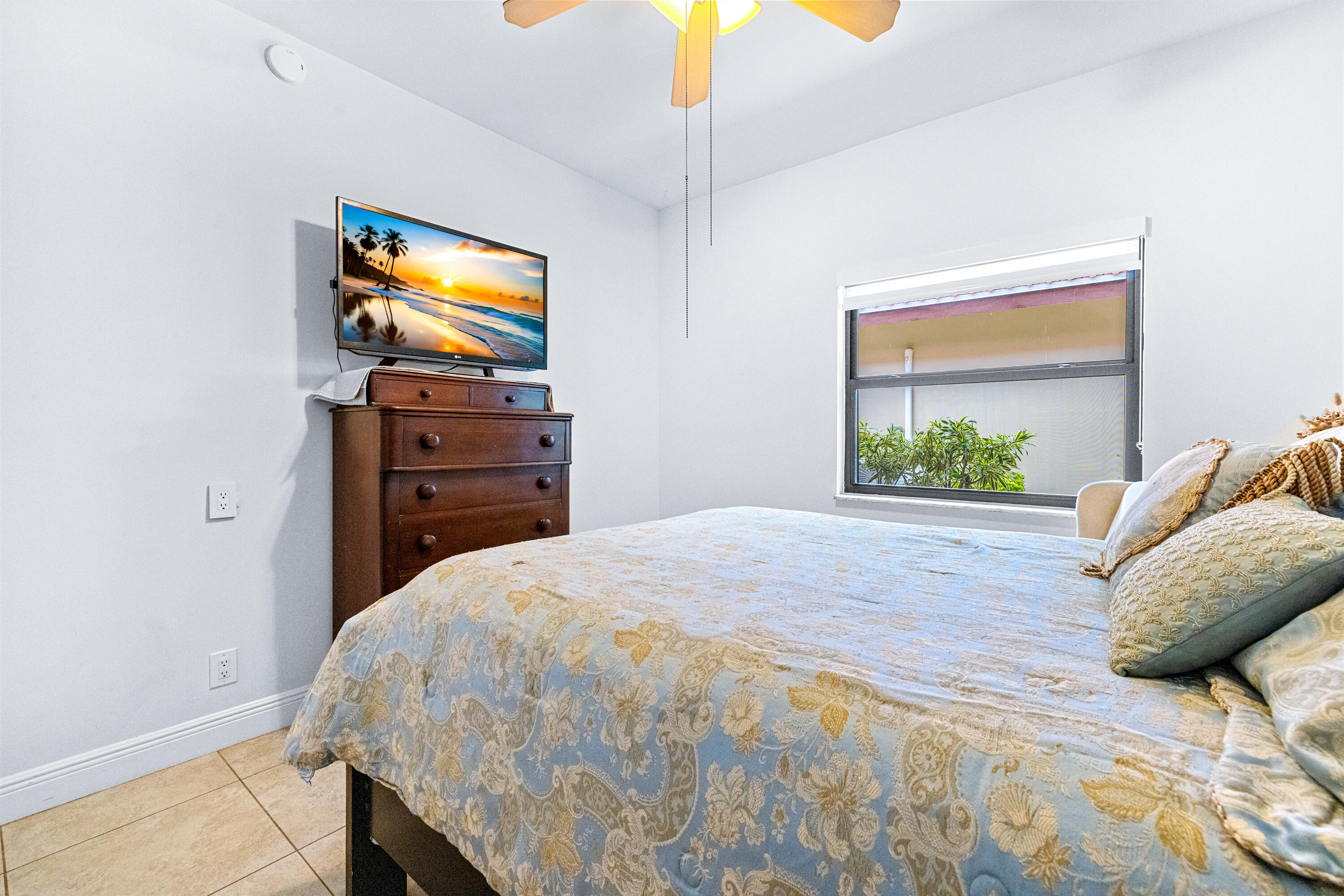 11415 Sundance Lane Boca Raton, FL 33428 - Photo 24 of 65 a bedroom with a bed and a flat screen tv