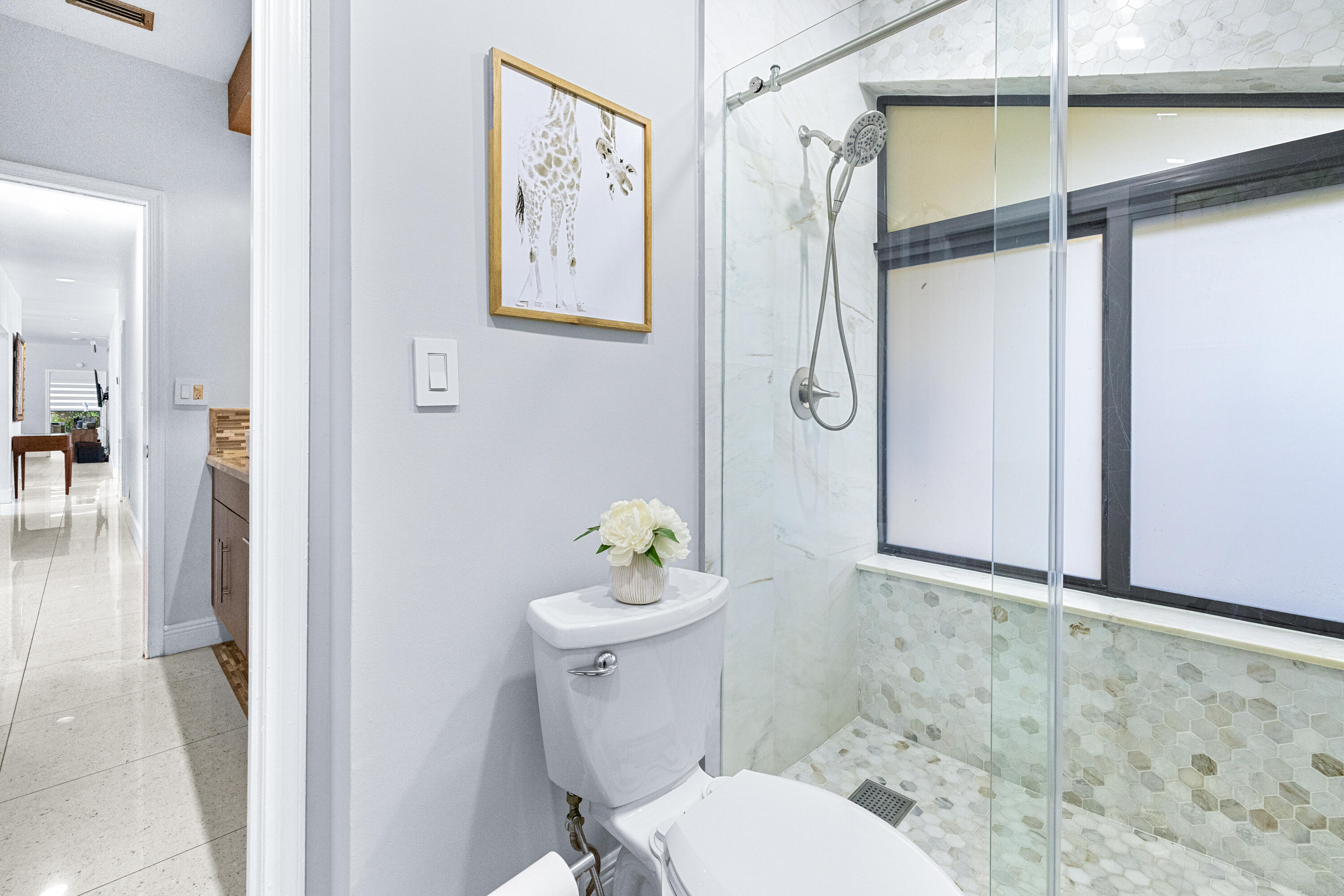 11415 Sundance Lane Boca Raton, FL 33428 - Photo 26 of 65 a white toilet sitting next to a bathroom sink