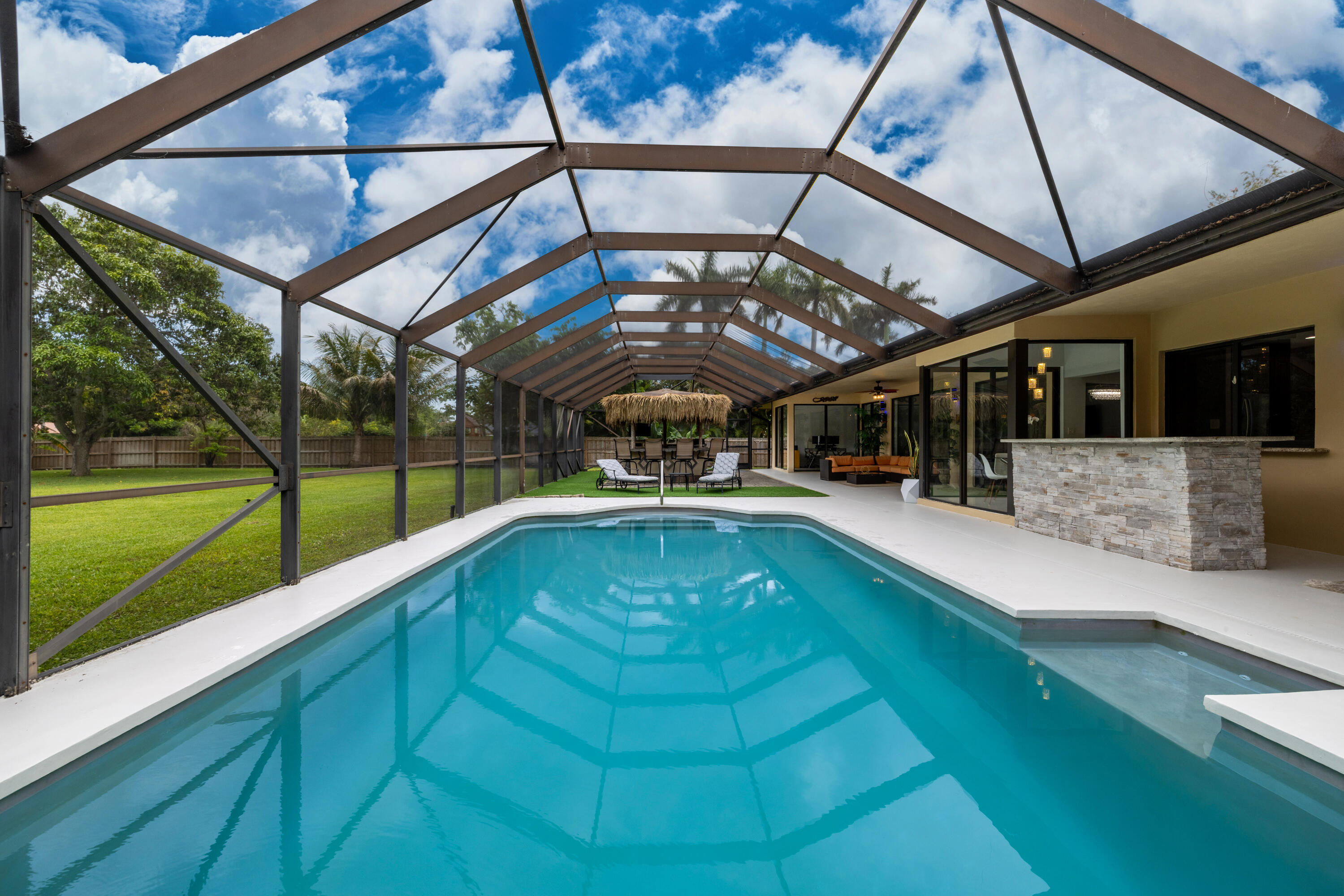 11415 Sundance Lane Boca Raton, FL 33428 - Photo 36 of 65 a view of a swimming pool with a porch