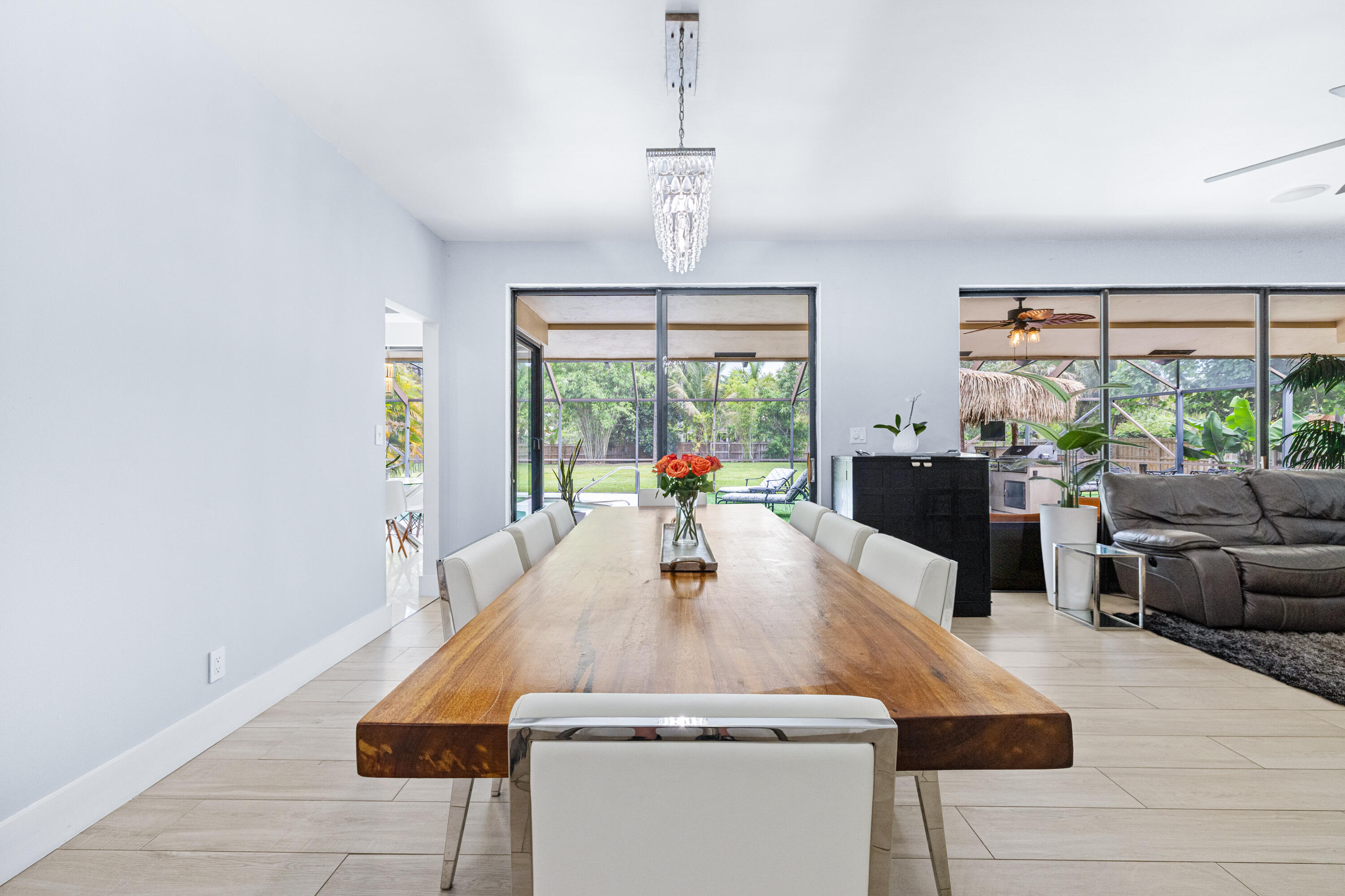 11415 Sundance Lane Boca Raton, FL 33428 - Photo 7 of 65 a dining room with furniture a chandelier and wooden floor