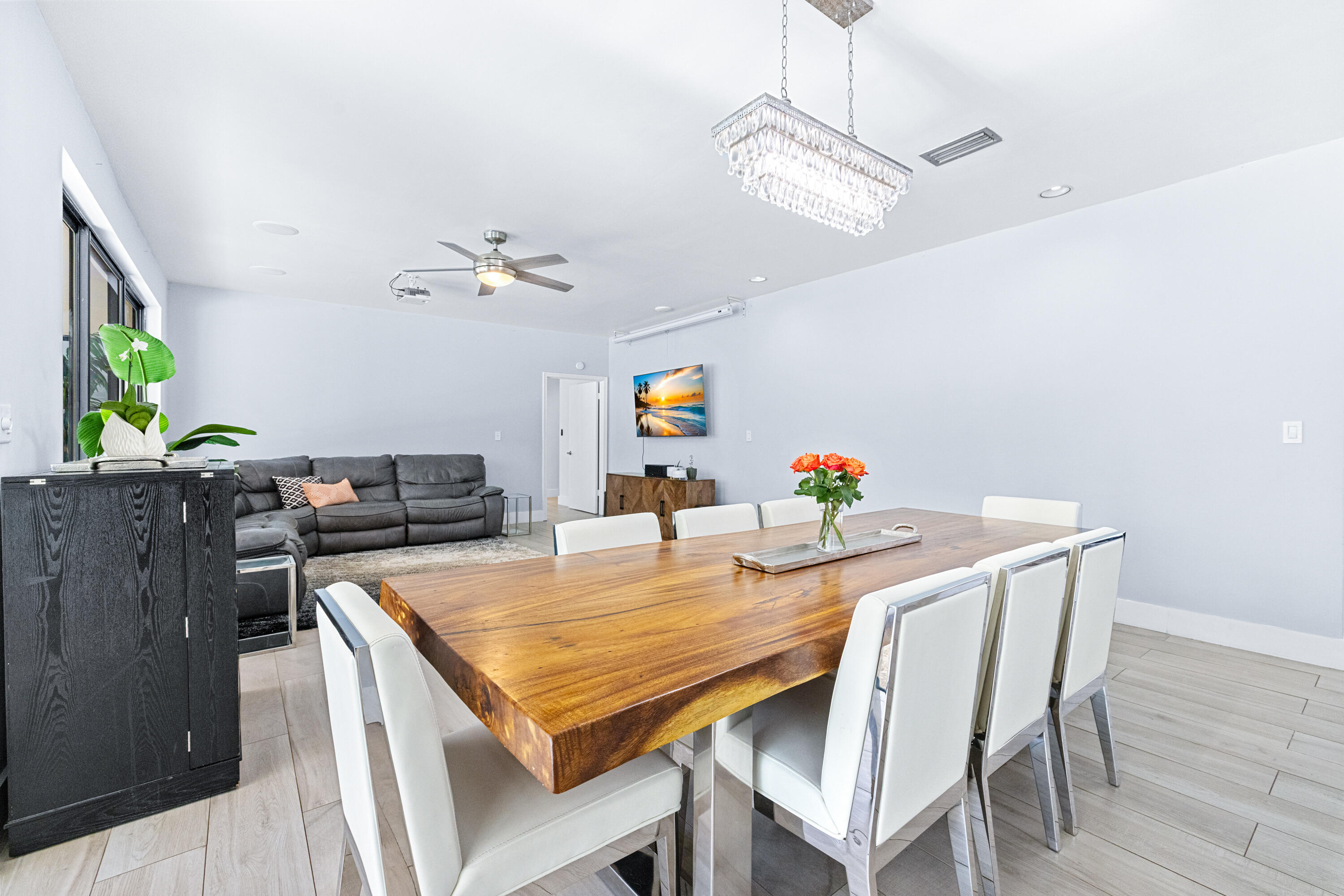 11415 Sundance Lane Boca Raton, FL 33428 - Photo 8 of 65 a view of a dining room with furniture and a chandelier
