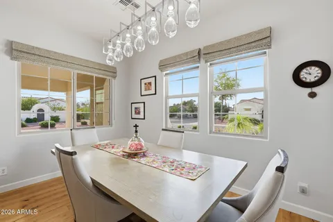 a dining room with furniture a chandelier and window