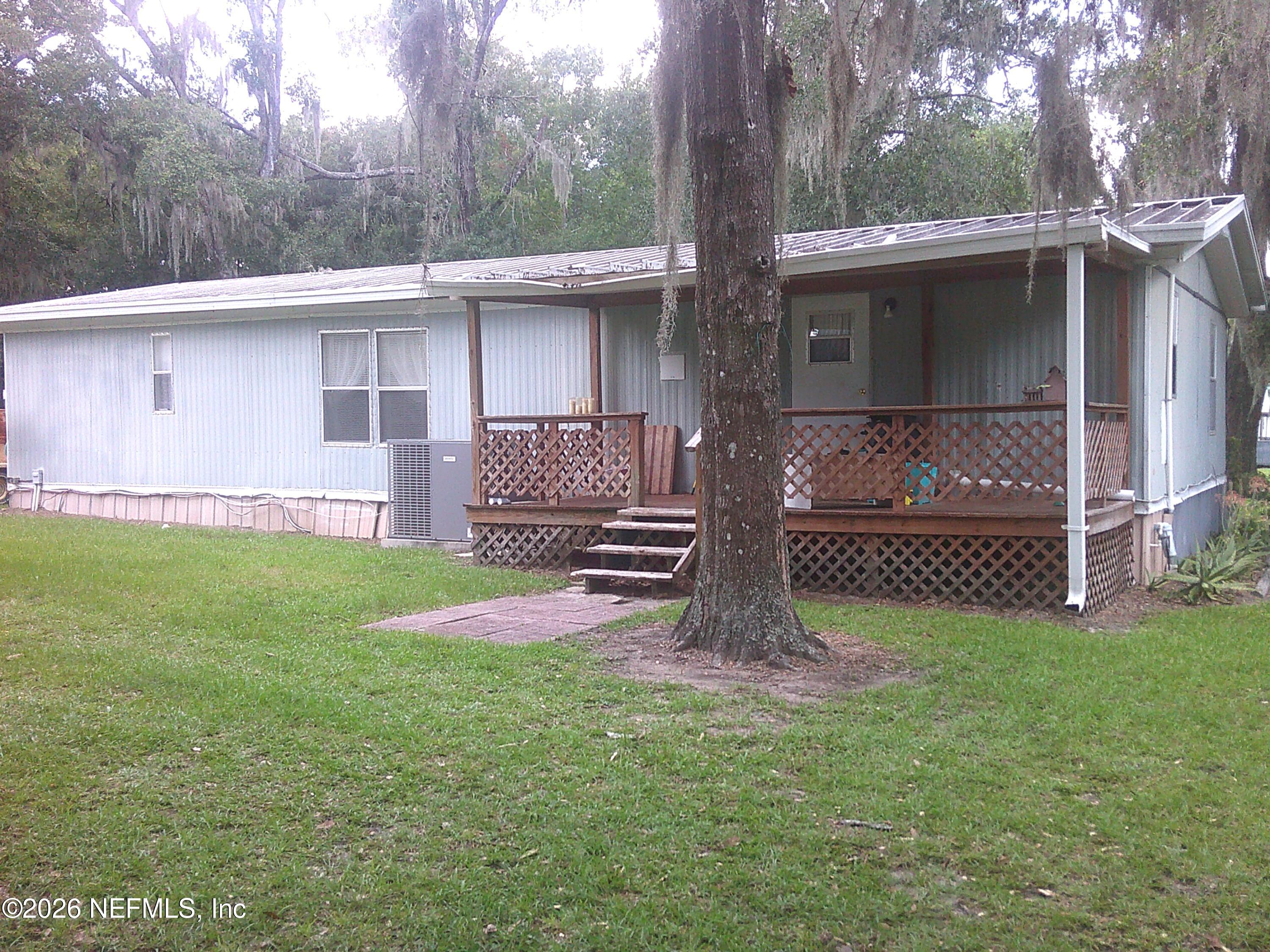 131 Pomona Landing Road Pomona Park, FL 32112 - Photo 16 of 19 a view of a house with a yard and a large tree