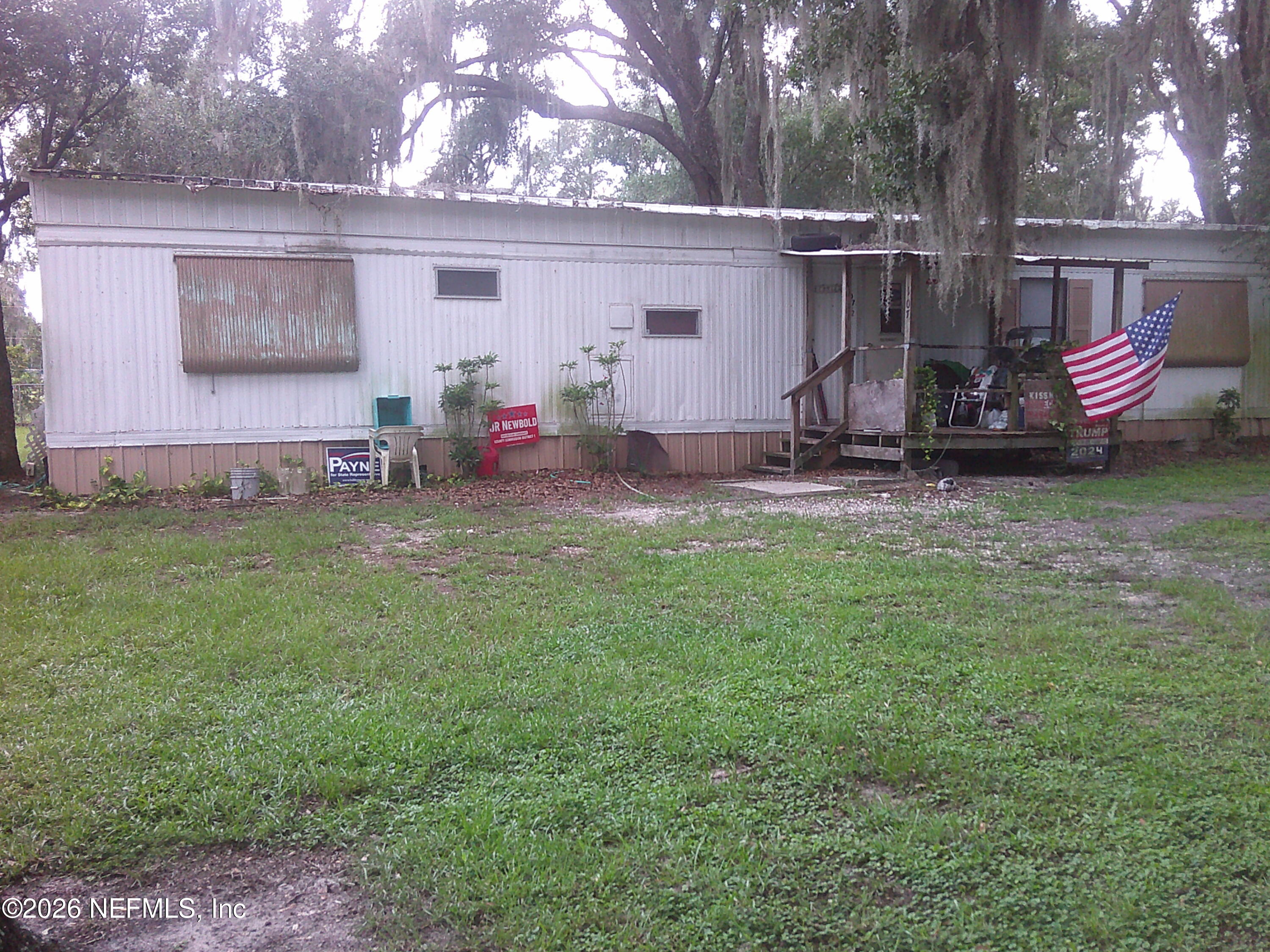 131 Pomona Landing Road Pomona Park, FL 32112 - Photo 17 of 19 a view of a backyard with table and chairs and a yard