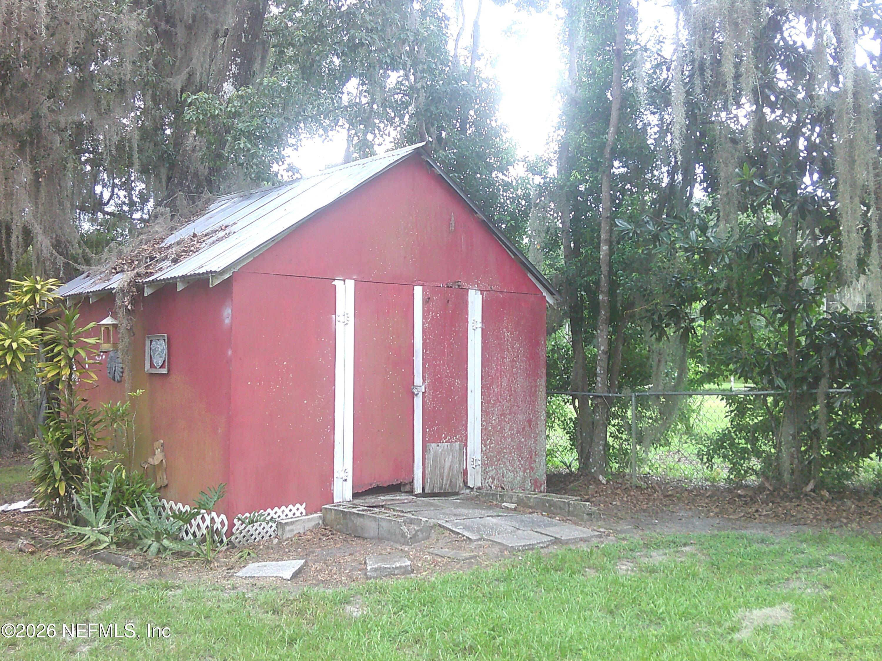 131 Pomona Landing Road Pomona Park, FL 32112 - Photo 19 of 19 a backyard of a house with large trees and a small yard