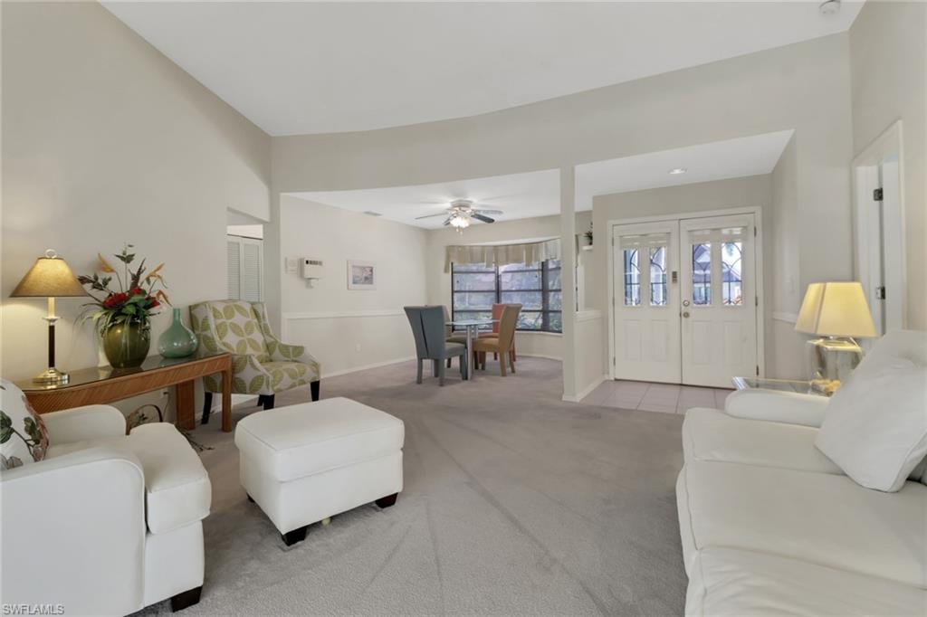 4961 Berkeley Drive Naples, FL 34112 - Photo 11 of 29 a living room with furniture and wooden floor