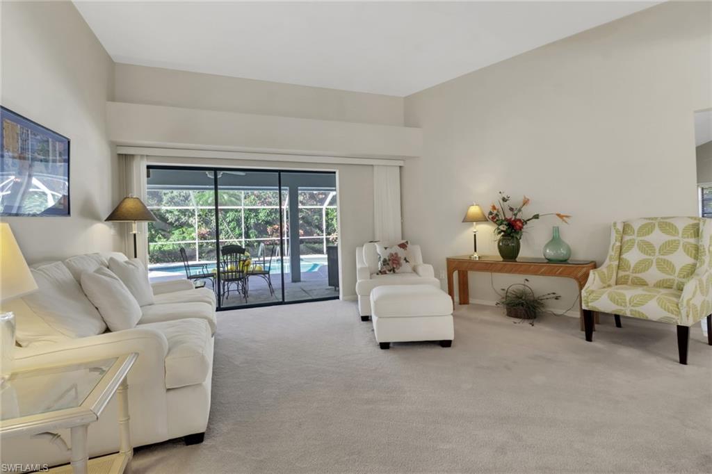 4961 Berkeley Drive Naples, FL 34112 - Photo 12 of 29 a living room with furniture and a large window with outer view