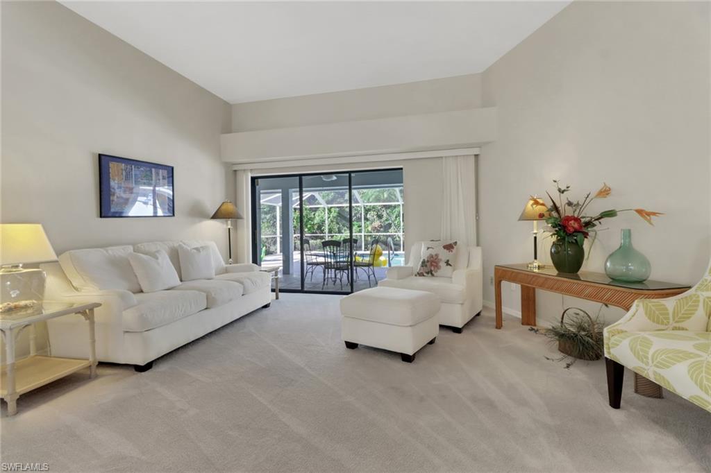 4961 Berkeley Drive Naples, FL 34112 - Photo 13 of 29 a living room with furniture and a large window