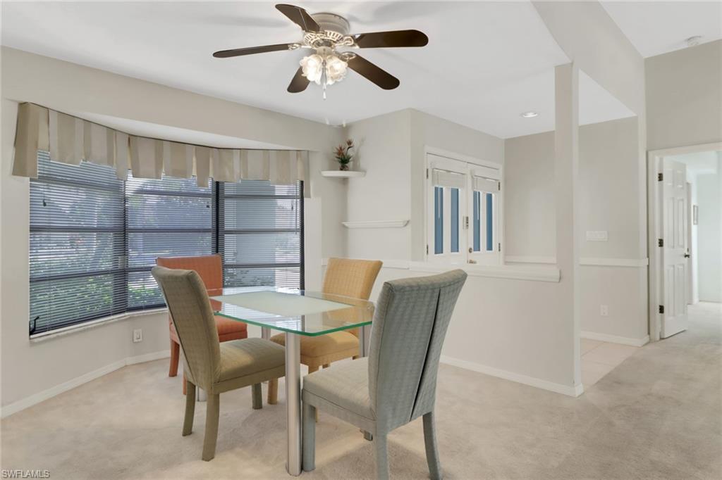 4961 Berkeley Drive Naples, FL 34112 - Photo 15 of 29 a view of a dining room with furniture