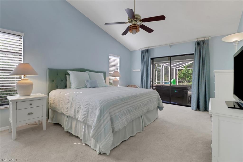 4961 Berkeley Drive Naples, FL 34112 - Photo 16 of 29 a bedroom with a large bed and a tv