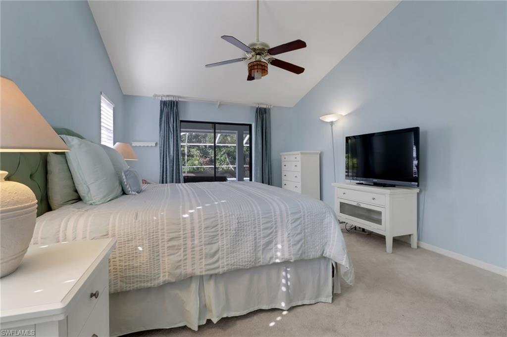 4961 Berkeley Drive Naples, FL 34112 - Photo 17 of 29 a bedroom with a bed and a flat screen tv