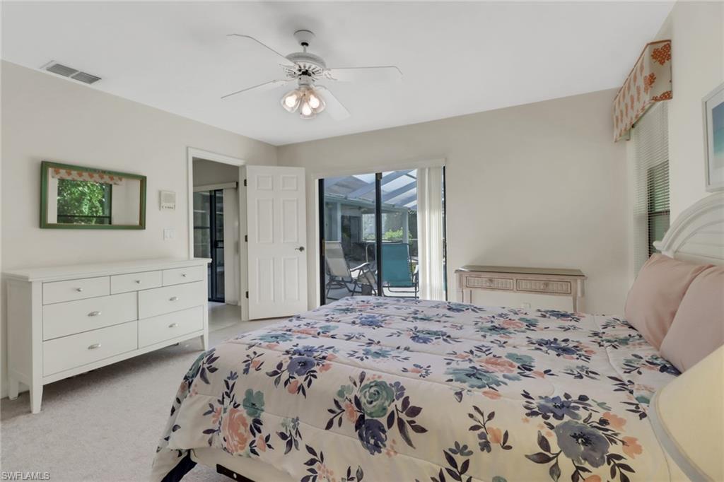 4961 Berkeley Drive Naples, FL 34112 - Photo 20 of 29 a bedroom with a bed and a dresser