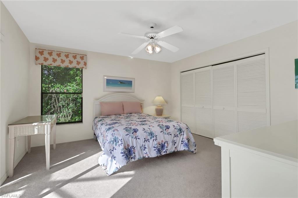 4961 Berkeley Drive Naples, FL 34112 - Photo 21 of 29 a bedroom with a bed and a window