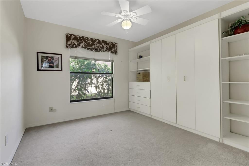 4961 Berkeley Drive Naples, FL 34112 - Photo 23 of 29 an empty room with windows and fan