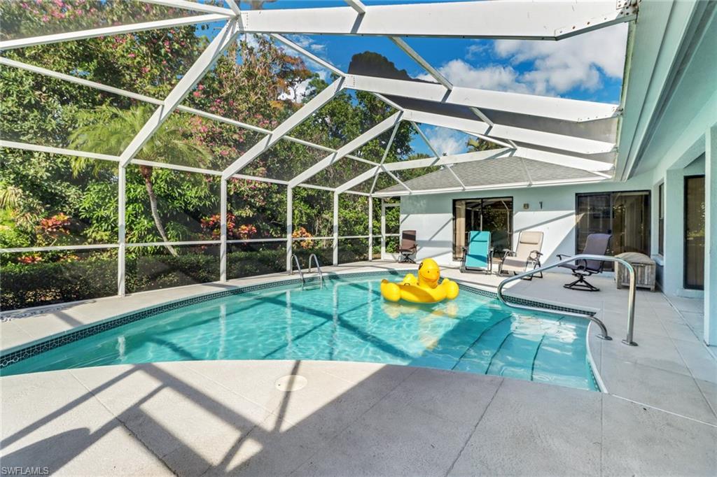 4961 Berkeley Drive Naples, FL 34112 - Photo 27 of 29 a view of a backyard with swimming pool and sitting area