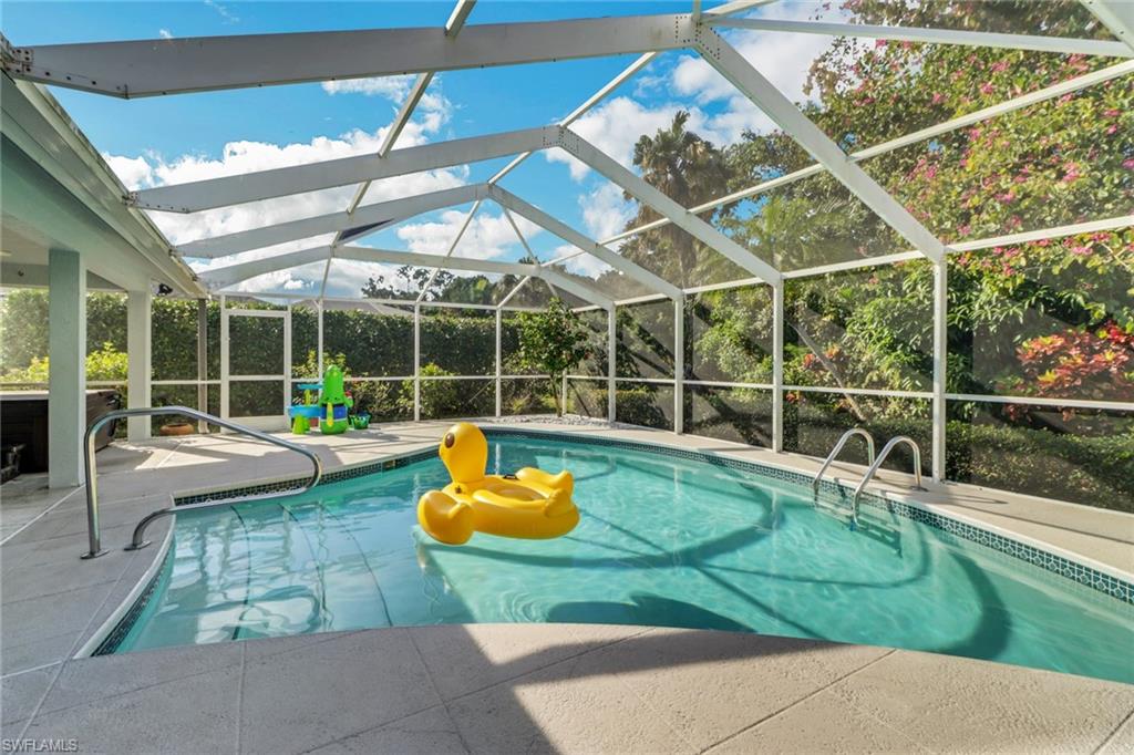 4961 Berkeley Drive Naples, FL 34112 - Photo 28 of 29 a view of a backyard with swimming pool and sitting area