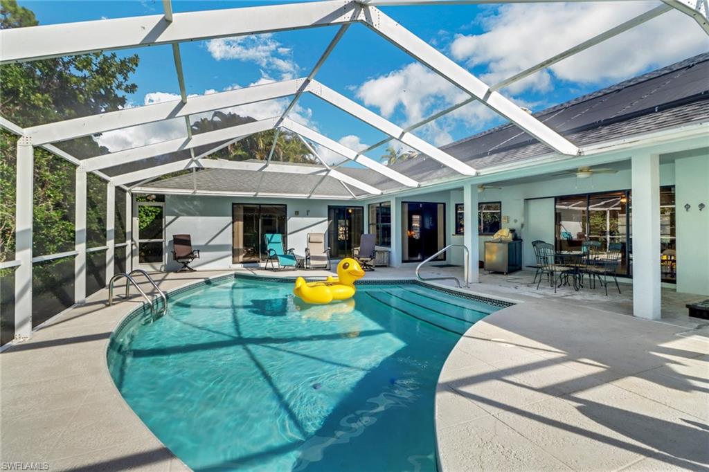 4961 Berkeley Drive Naples, FL 34112 - Photo 29 of 29 a view of a swimming pool with a patio and a yard