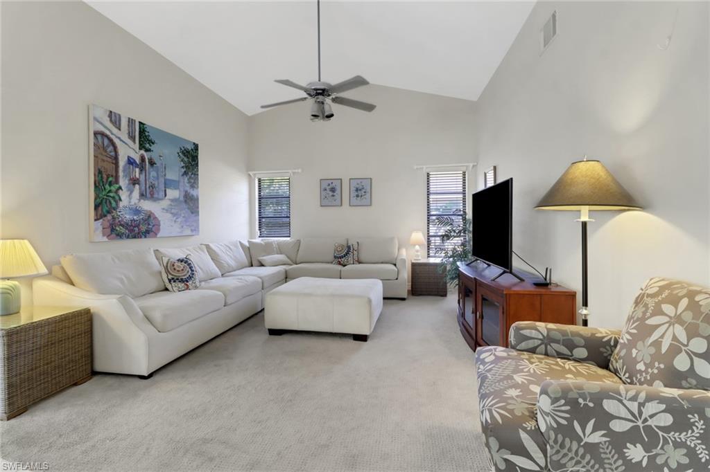 4961 Berkeley Drive Naples, FL 34112 - Photo 8 of 29 a living room with furniture and a flat screen tv