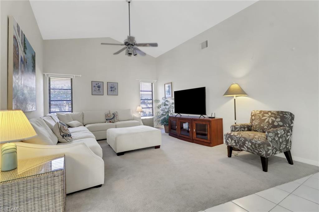 4961 Berkeley Drive Naples, FL 34112 - Photo 10 of 29 a living room with furniture and a flat screen tv