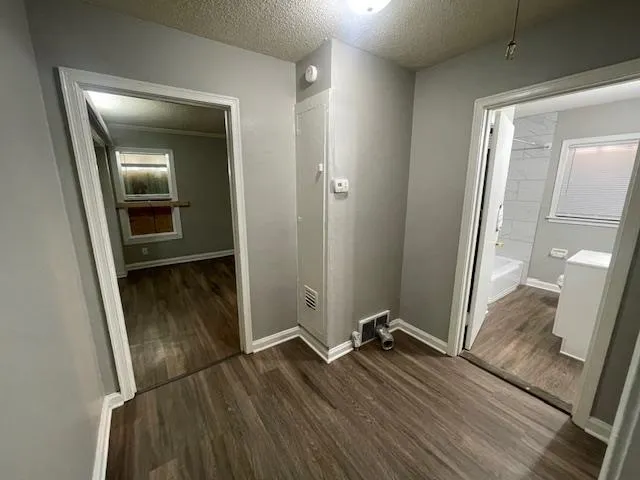 a room with wooden floor and mirror